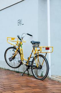 Defect broken flat tire locked post delivery bicycle by Markus Spiske